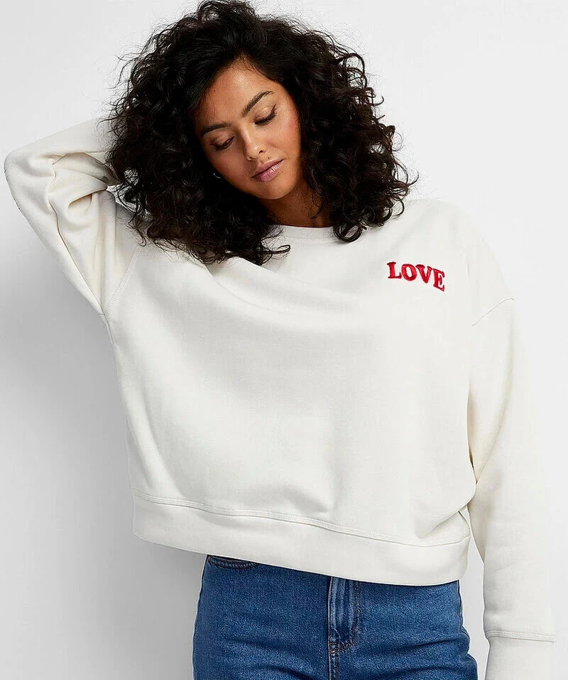 female wearing white sweatshirt printing on front with white background