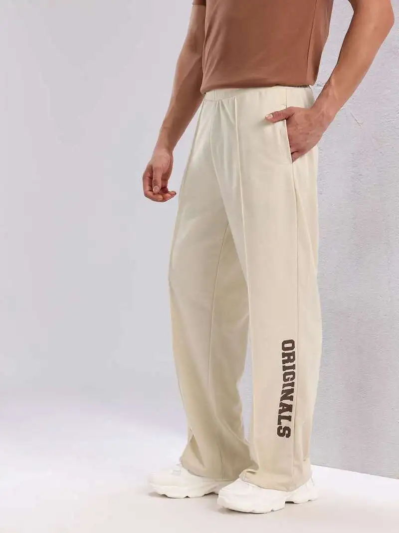 male wearing custom sweatpants in cream color with white background