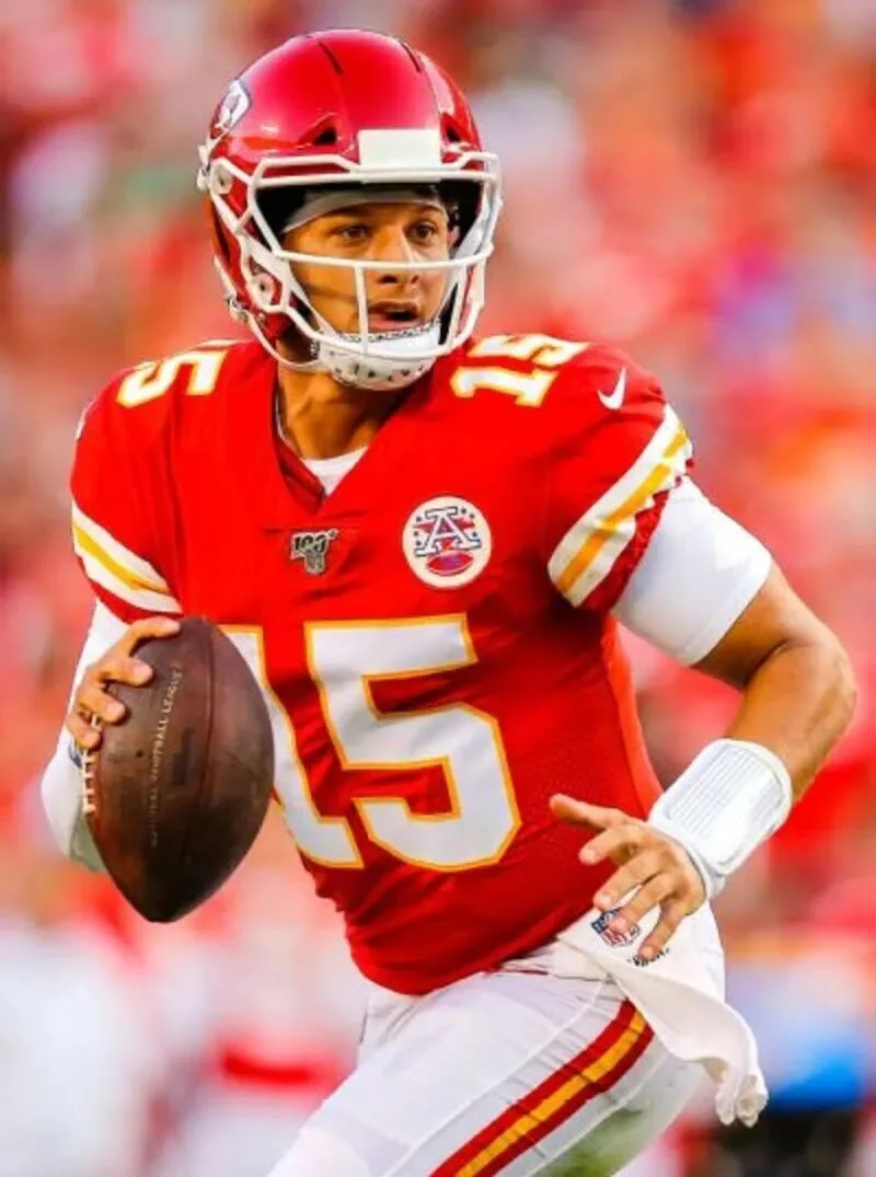 player wearing red and white custom sublimation American football uniform running in stadium