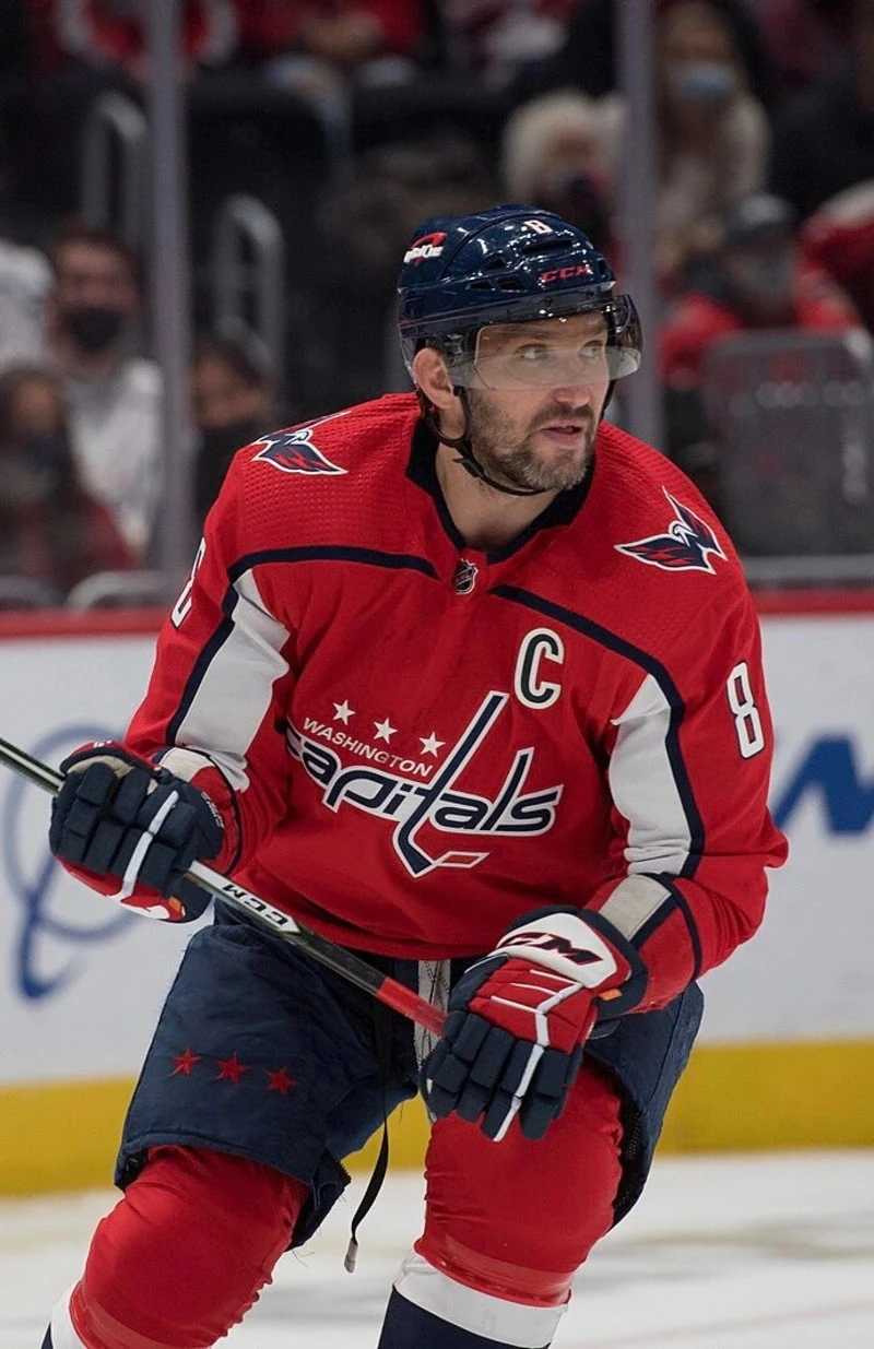 player wearing custom red ice hockey uniform plying in field