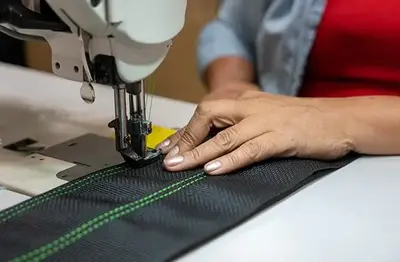 sewing process at cheez clothing factory in Sialkot Pakistan
