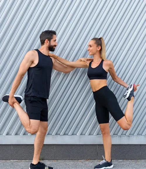 Couple Wearing Custom Gym Shorts and Tops
